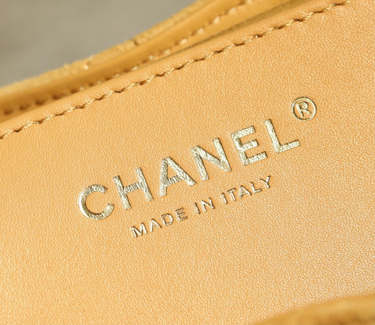 Pumpkin yellow Chanel hobo 25 price guide image with suede texture and compact daily-carry shape