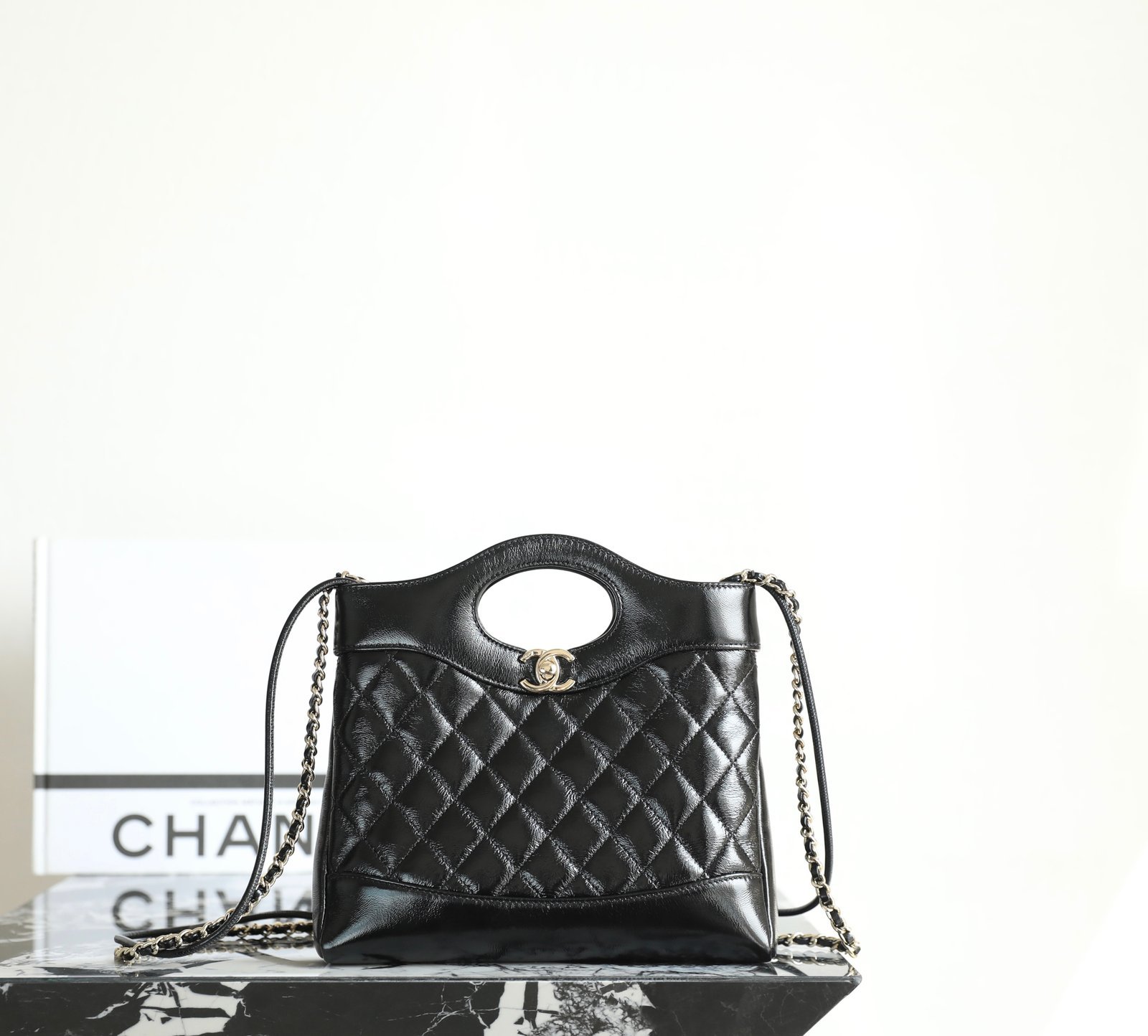 CHANEL 31 Nano Shopping Bag – Black Lambskin with 14K Light Gold Hardware detail image 1 sourced from womanlvbag.com