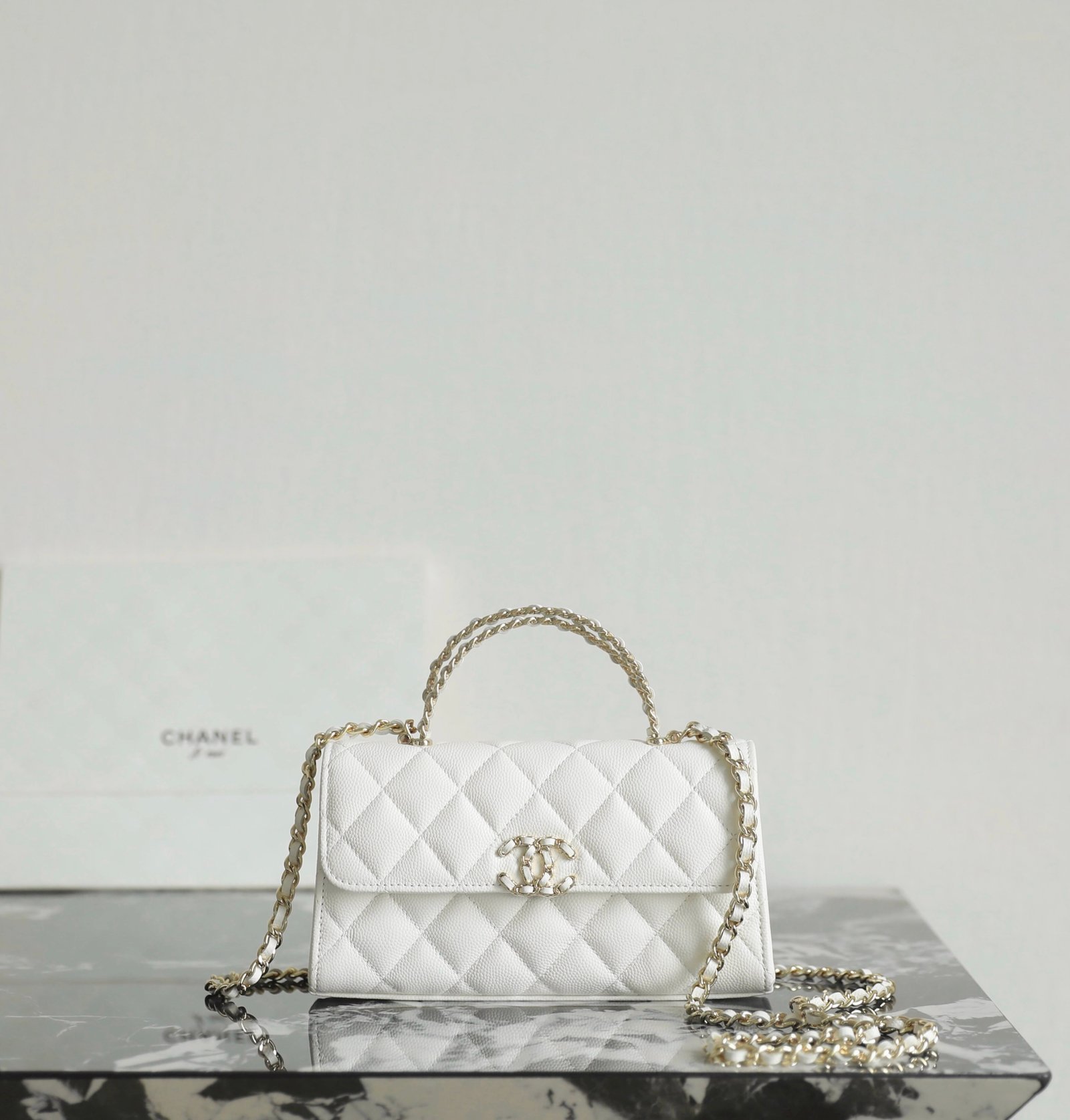 White Chanel bag guide: Chanel Mini Kelly Crisscross Handle Flap Bag in white caviar leather with light gold hardware