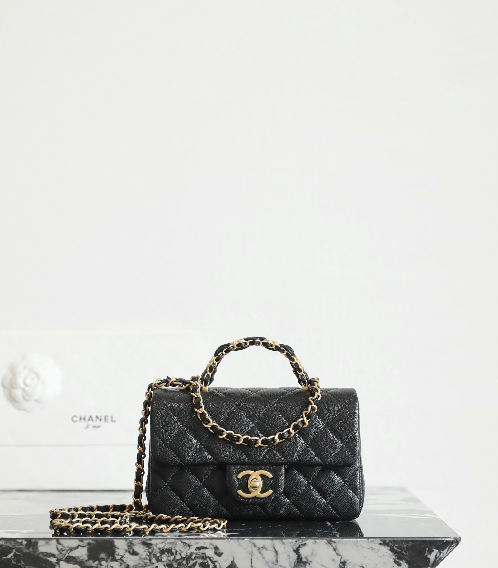 CHANEL Mini Classic Flap Bag with Leather-Intertwined Handle – Black Caviar with 24K Vintage Gold Hardware detail image 1 sourced from womanlvbag.com