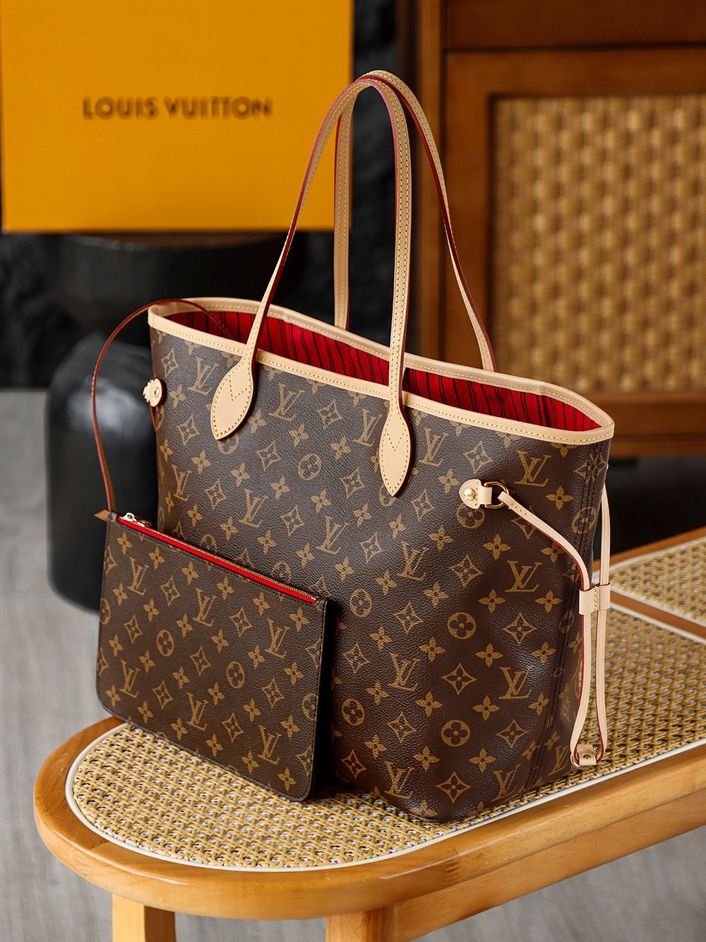 LV M41177 bag interior view showing cerise red striped lining and detachable pouch details