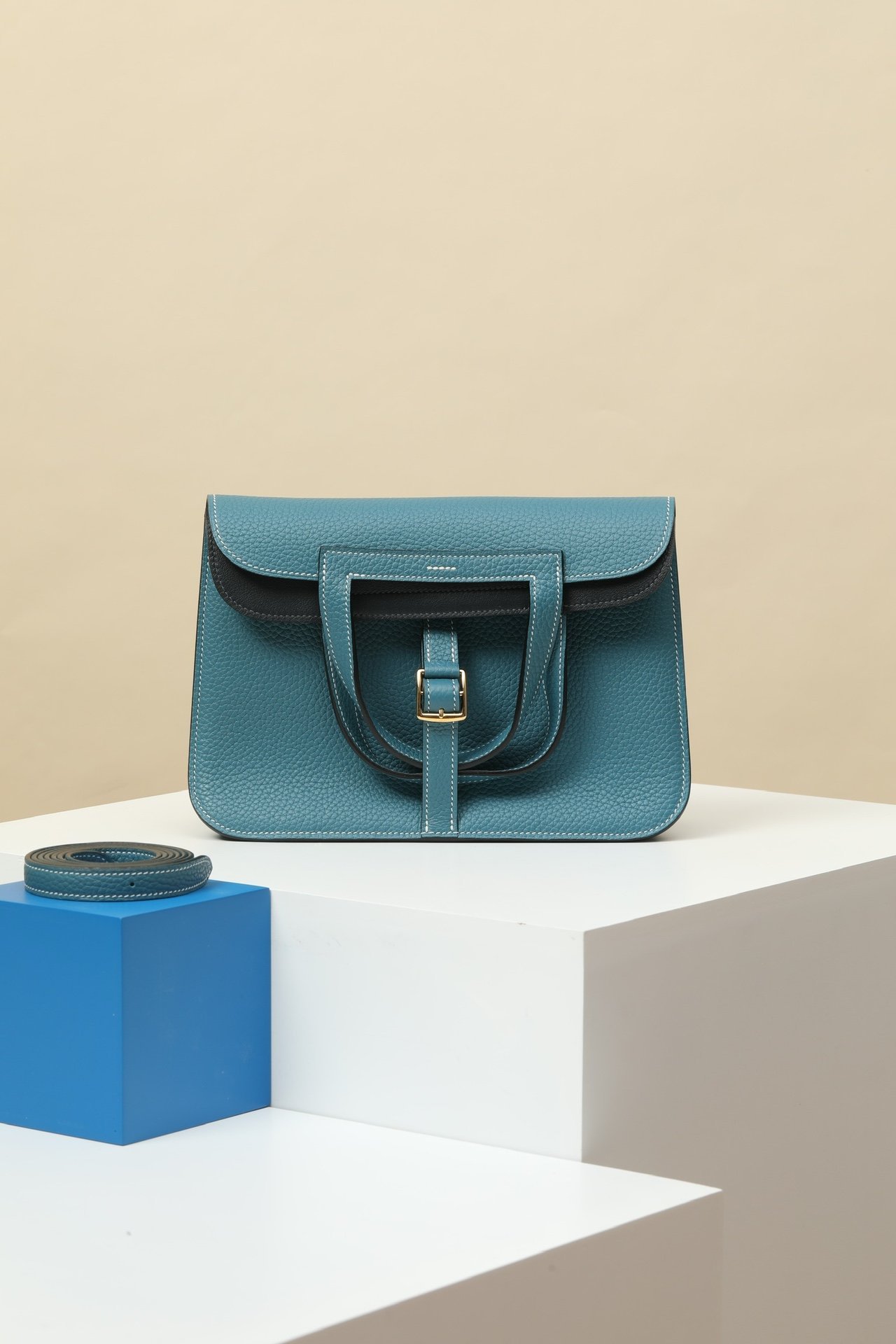 Hermès Halzan 25 – Clemence/Swift Leather CK75 Bleu Jean & 3Y Bleu Glacier GHW comparison image 1 sourced from womanlvbag.com