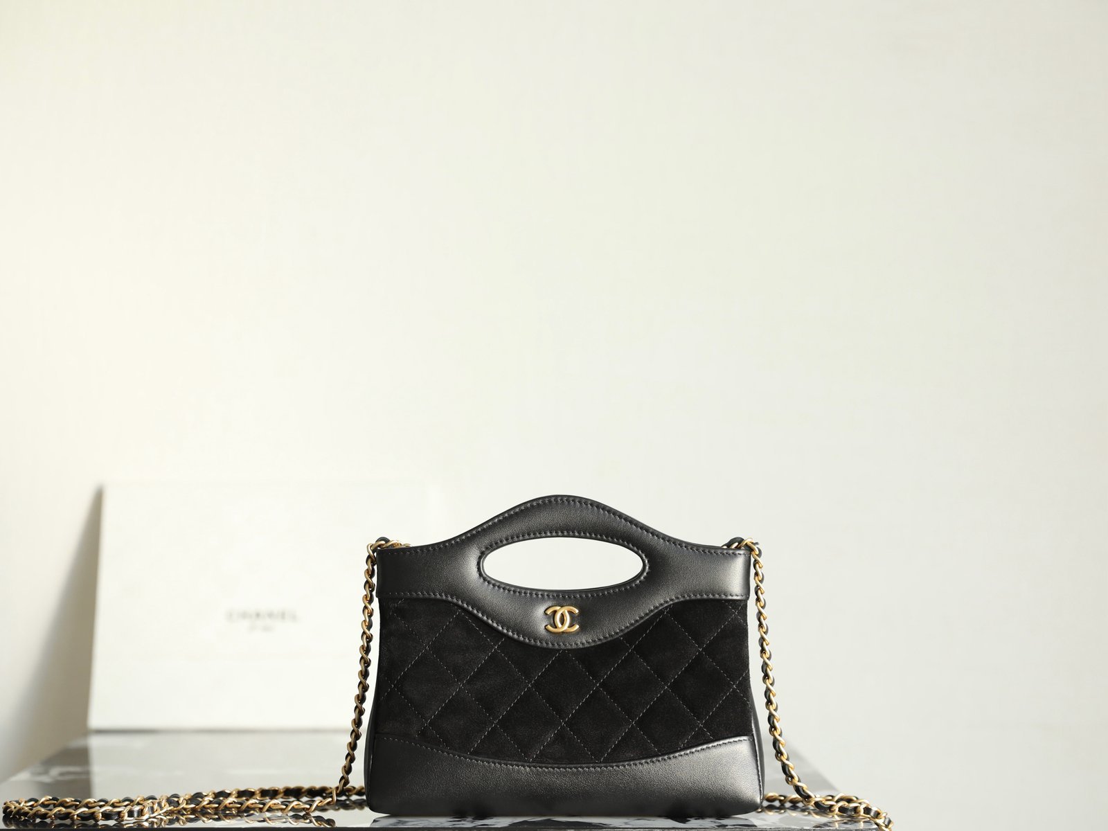 CHANEL 31 Nano Shopping Bag – Black Suede & Lambskin Mixed Media with 14K Light Gold Hardware detail image 1 sourced from womanlvbag.com