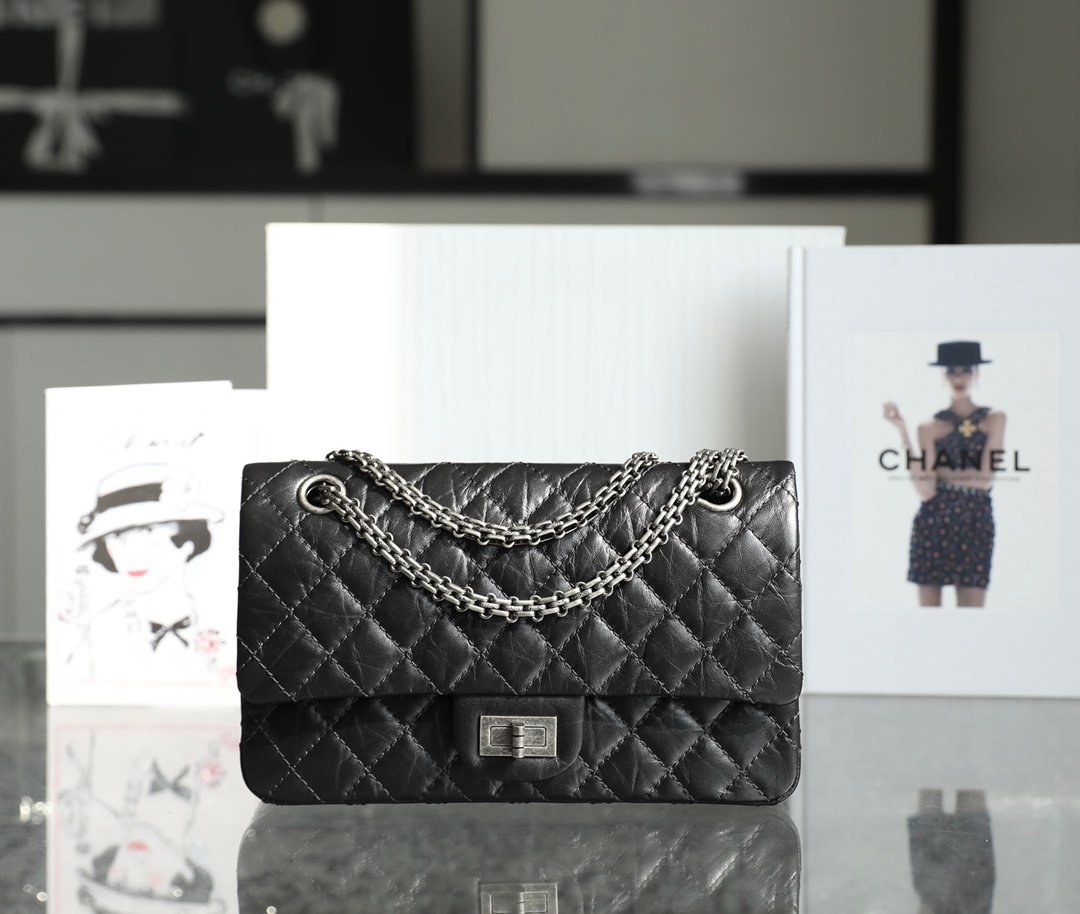 CHANEL Medium 2.55 Reissue Flap Bag – Black Aged Calfskin with Vintage Silver Mademoiselle Lock detail image 1 sourced from womanlvbag.com