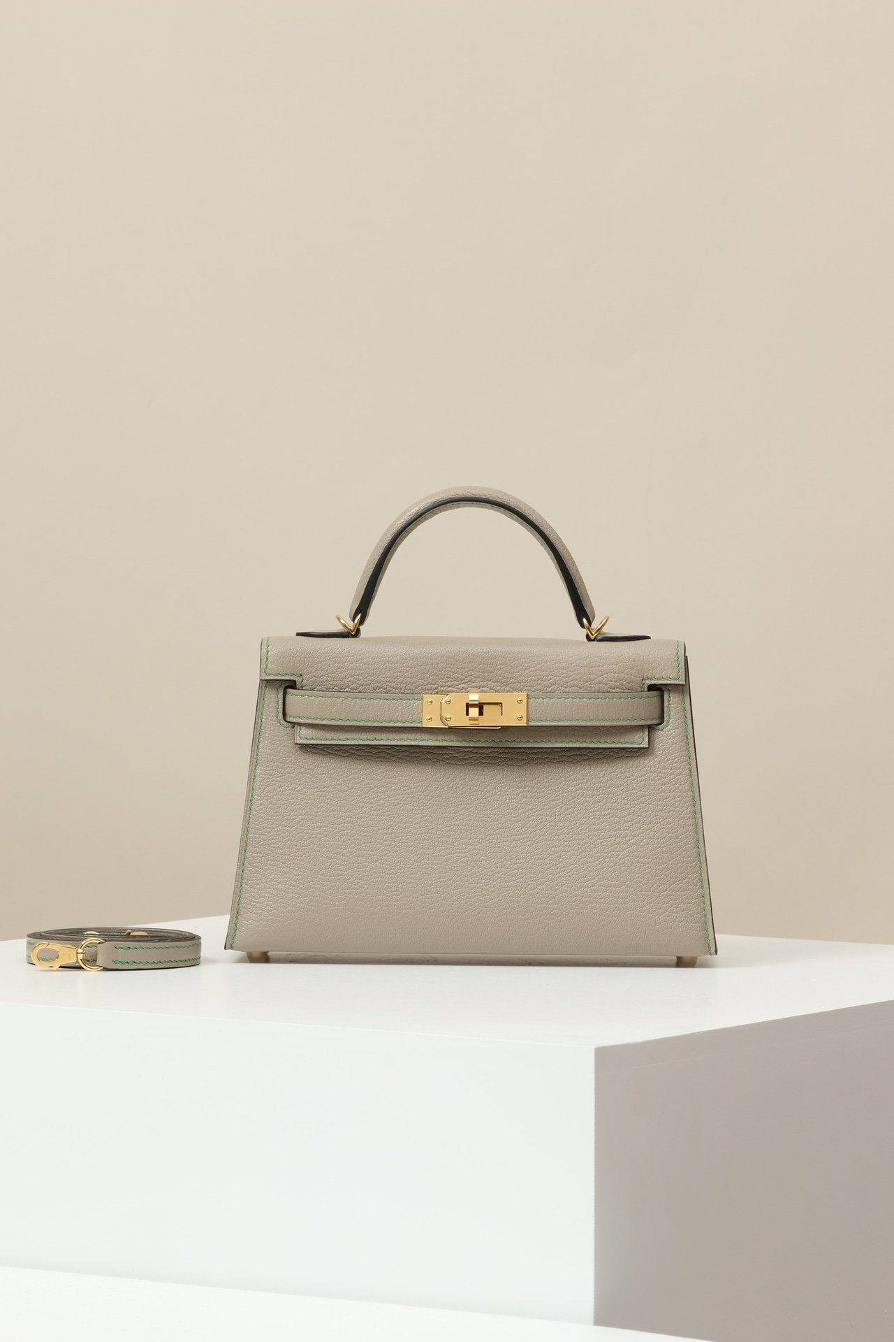 Hermes Mini Kelly 19 G2 – Chevre Gris Tourterelle (81) & Cactus (1L) GHW comparison image 1 sourced from womanlvbag.com